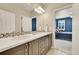 Clean bathroom with double sinks and view of bedroom at 14672 Melco Ave, Parker, CO 80134