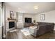 Spacious living room with a corner fireplace and large sectional sofa at 728 Larkspur Ct, Brighton, CO 80601