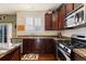 Bright kitchen with granite countertops, stainless steel appliances and wood flooring at 8104 El Jebel Loop, Castle Rock, CO 80108