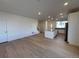 Open-concept living area with hardwood floors and kitchen view at 14555 W 91St Ave # A, Arvada, CO 80005