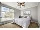 Cozy bedroom featuring a double bed, window, and ceiling fan at 1132 S Salida Way, Aurora, CO 80017