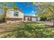 Ranch style home with brick facade, attached garage, and mature landscaping at 1132 S Salida Way, Aurora, CO 80017