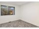 Simple bedroom with gray carpeting and a window providing natural light at 7995 E Mississippi Ave # C2, Denver, CO 80247