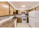 Galley kitchen with granite countertops and appliances at 9655 E Center Ave # 6D, Denver, CO 80247