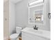 Updated bathroom with white vanity, new fixtures, and a large mirror at 806 W Peakview Ave, Littleton, CO 80120