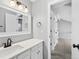 Bathroom with white vanity, updated fixtures and access to hallway at 806 W Peakview Ave, Littleton, CO 80120