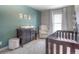 Charming Bedroom with crib, dresser, and rocking chair at 11597 N Settlers Dr, Parker, CO 80138