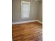 Spacious bedroom with hardwood floors and large window at 1350 N Ulster St, Denver, CO 80220