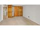 Spacious carpeted bedroom with double doors leading to laundry and storage at 4201 S Richfield Way, Aurora, CO 80013