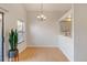 Dining room with hardwood floors, a chandelier, and adjacent kitchen at 4201 S Richfield Way, Aurora, CO 80013