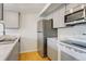 Modern kitchen with gray cabinets, marble countertops, and stainless steel appliances at 4201 S Richfield Way, Aurora, CO 80013