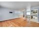 Hardwood floors and view into kitchen area at 6103 Uno St, Arvada, CO 80003