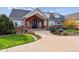 Two-story home with gray siding and brick accents, landscaped front yard, and a large driveway at 29850 E 167Th Pl, Brighton, CO 80603