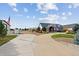 House exterior with a large driveway and American Flag at 29850 E 167Th Pl, Brighton, CO 80603