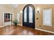 Elegant entryway with arched double doors, hardwood floors, and plantation shutters at 29850 E 167Th Pl, Brighton, CO 80603