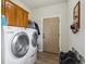 Laundry room with washer, dryer, and built-in cabinets at 29850 E 167Th Pl, Brighton, CO 80603