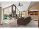 Spacious living room with a large fireplace, built-in shelving, and access to backyard at 29850 E 167Th Pl, Brighton, CO 80603