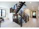 Modern floating staircase with metal railing and wood steps at 2200 Newton St, Denver, CO 80211