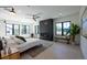 Bright main bedroom with a fireplace, hardwood floors, and large windows at 2200 Newton St, Denver, CO 80211