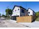 Contemporary home with wooden fence and two-car garage at 2200 Newton St, Denver, CO 80211