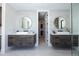 Double vanity bathroom with modern floating cabinets and large mirrors at 2200 Newton St, Denver, CO 80211