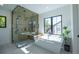 Spa-like bathroom with a large shower, soaking tub, and modern fixtures at 2200 Newton St, Denver, CO 80211