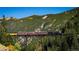 Train on a high bridge with mountain view and fall foliage at 2121 Hummingbird Way # 104, Georgetown, CO 80444