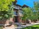 Modern brick townhome with landscaping and balcony at 6435 E Cedar Ave, Denver, CO 80224