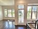 Bright living room with hardwood floors and access to a balcony at 6435 E Cedar Ave, Denver, CO 80224