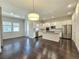 Open concept kitchen with island, stainless steel appliances, and hardwood floors at 6435 E Cedar Ave, Denver, CO 80224