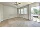 Bright bedroom with carpet flooring and access to a balcony at 6435 E Cedar Ave, Denver, CO 80224