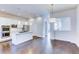 Bright kitchen with white cabinets, an island, and hardwood floors at 6435 E Cedar Ave, Denver, CO 80224