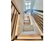 Elegant staircase with modern railing and carpet runner at 6435 E Cedar Ave, Denver, CO 80224