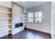 Living room with a built-in fireplace and white shelving at 6435 E Cedar Ave, Denver, CO 80224
