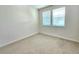 Well-lit bedroom with carpet and two windows at 6435 E Cedar Ave, Denver, CO 80224