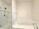 Bathroom with shower and soaking tub, subway tile and built-in shelving at 6435 E Cedar Ave, Denver, CO 80224