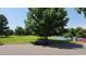 Residential street view with park and tennis court in background at 6435 E Cedar Ave, Denver, CO 80224