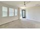Spacious bedroom with carpet, ceiling fan and private balcony access at 6435 E Cedar Ave, Denver, CO 80224