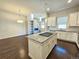 Open concept kitchen with an island and hardwood floors at 6435 E Cedar Ave, Denver, CO 80224