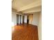 Bright bedroom with hardwood floors and a barn door leading to the bathroom at 9725 E Harvard Ave # 322, Denver, CO 80231