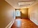 Bright bedroom with wood floors and large window at 3414 S Locust St # D, Denver, CO 80222