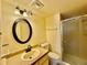Updated bathroom with a shower/tub combo and oval mirror at 3414 S Locust St # D, Denver, CO 80222