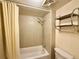 Clean bathroom with shower/tub combo and shelving at 3414 S Locust St # D, Denver, CO 80222
