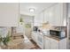 White kitchen with granite countertops and modern appliances at 9901 E Evans Ave # 7D, Aurora, CO 80247