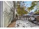 Side view of townhome showing walkway and snowy landscaping at 9901 E Evans Ave # 7D, Aurora, CO 80247
