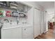 Laundry room with washer, dryer, and shelving for storage at 9901 E Evans Ave # 7D, Aurora, CO 80247