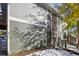 Side view of townhome with snowy landscaping and wooden fence at 9901 E Evans Ave # 7D, Aurora, CO 80247