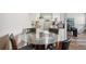 Bright dining area with glass table and four chairs, kitchen view at 9901 E Evans Ave # 7D, Aurora, CO 80247