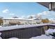 Snowy view of neighboring townhomes from a private deck at 9901 E Evans Ave # 7D, Aurora, CO 80247