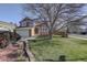 Two-story house with attached garage, landscaping, and large tree at 926 Highland Park Dr, Broomfield, CO 80020